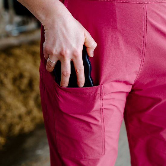 Person wearing pink overalls with a blurred background