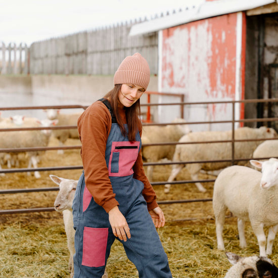 Woman in a barn with sheep